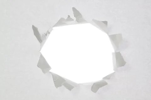 Broken a hole in a sheet of paper Stock Photos