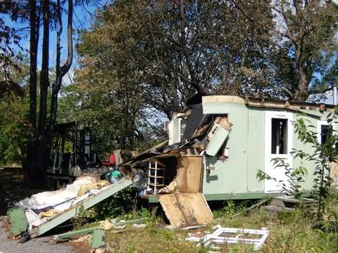 Broken house with garbage and windows Stock Photos