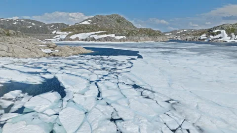 Broken ice sheets floating on alpine lake at Hardangervidda National Park. Stock Footage 328130534