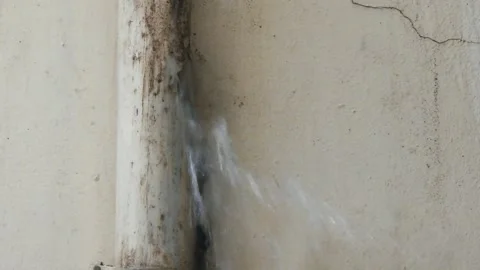 Broken Indoor Water Pipe Leaking During Rainy Weather - Wall Damage Closeup Stock Footage 333952409