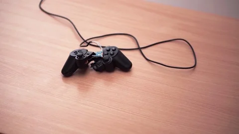 Broken joystick from Sony PlayStation on table Stock Footage 84184911