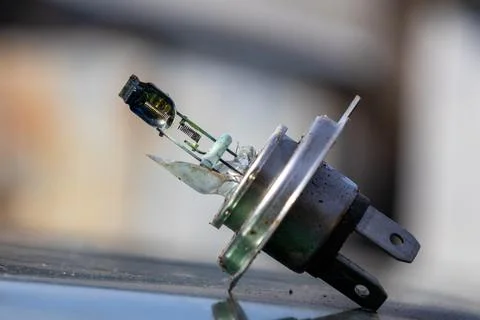 Broken Lamp Component Sits on a Surface, Revealing Its Inner Parts and Dama.. Stock Photos