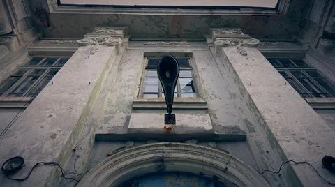 Broken lantern on the wall of an abandoned Soviet school. Stock Photos