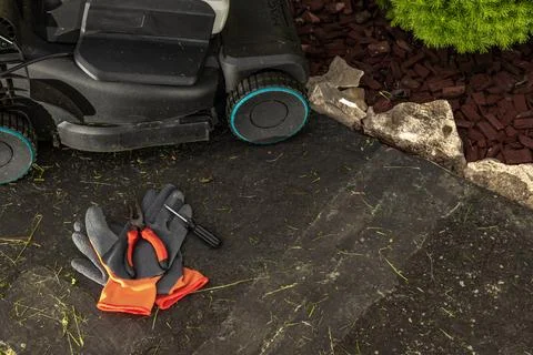 Broken Lawn Mower in Garden During Repair and Maintenance Work Stock Photos