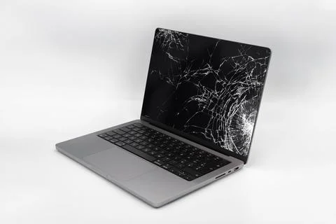 Broken LCD display on laptop computer. Isolated white background. Stock Photos