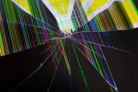 Broken LCD screen with spiderweb cracks and vibrant multicolored vertical p.. Stock Photos