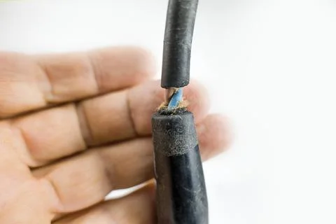 Broken machine electric power cable on a white Stock Photos