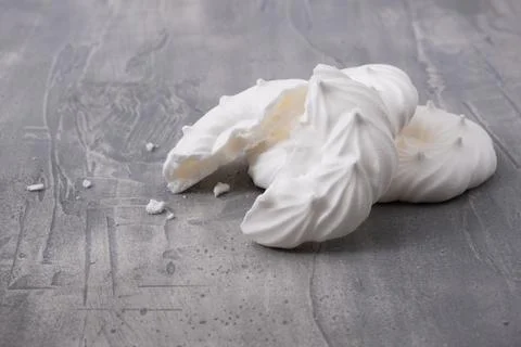 Broken meringues on gray background Stock Photos