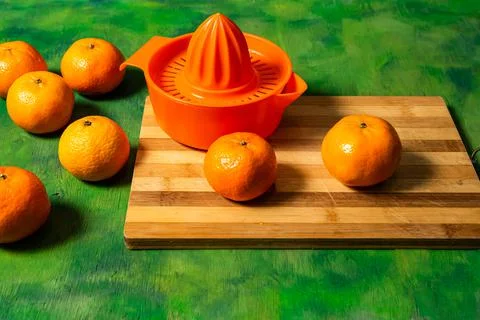 Broken mesh bag of oranges on an old wooden background in shades of green wit Stock Photos