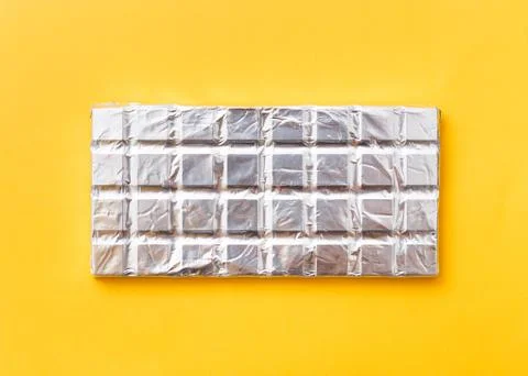 Broken milk chocolate pattern, top view flat lay on background Foto stock