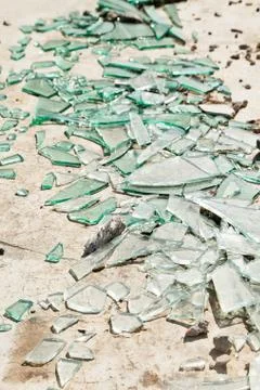 Broken mirror glass shards spread on the floor Stock Photos