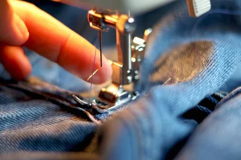 Broken needle in a sewing machine. The needle broke while sewing thick fabric Stock Photos