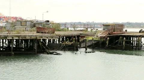 Broken old disused pier with large ship in background Stock Footage 46072279