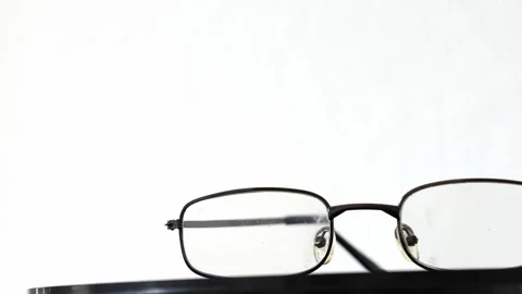 Broken old glasses on white background, spinning 360 view Stock Footage 333499264