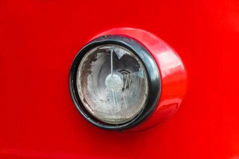 Broken old round headlight of red tram Stock Photos