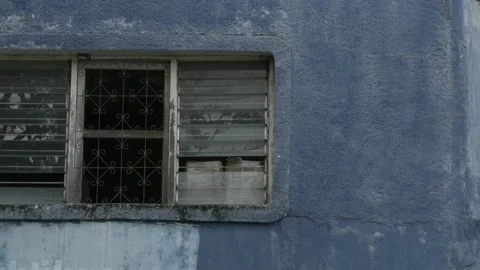 Broken old weathered windows of abandoned building near Sudi Mampir market Stock Footage 156997266