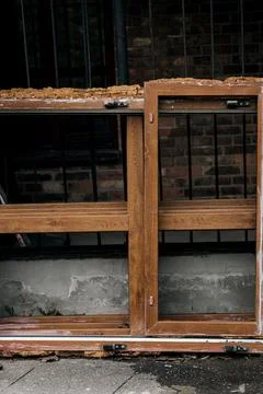 Broken old window next to a ruined house Stock Photos