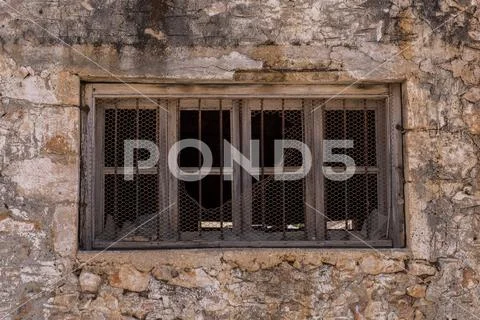 Broken old window set in a decaying wall Stock Photos