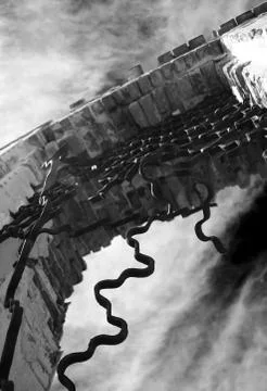 Broken openwork grille against the sky. Stock Photos