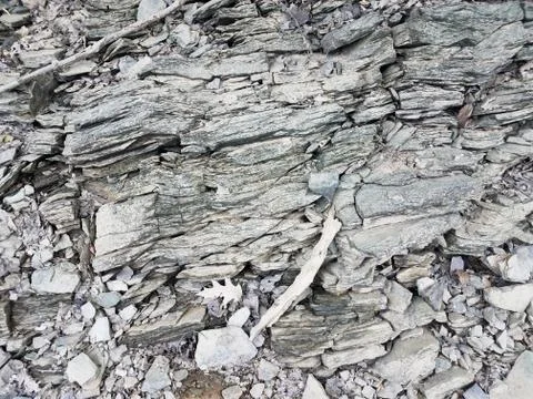 Broken or chipped grey rocks on the ground Foto stock