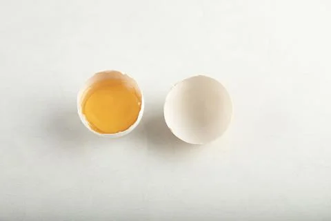 Broken organic egg on white background Stock Photos