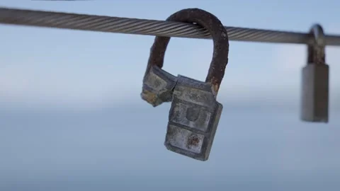 Broken Padlock Hanging on Steel Cable Against Blue horisont. 스톡 동영상 311622182