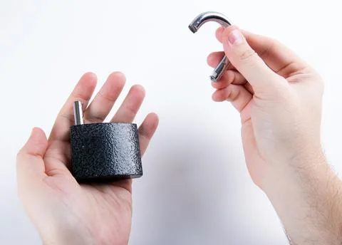 Broken padlock in the human hands top view closeup Foto stock