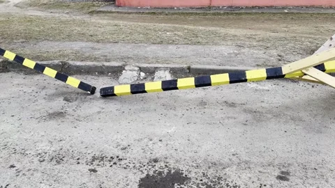 A broken parking barrier on an empty road, a damaged wooden barrier Stock-Footage 331331999