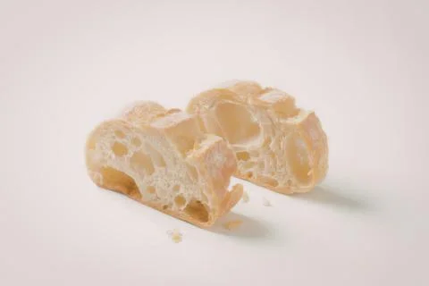 Broken piece of cheesy bread on plain background Foto stock