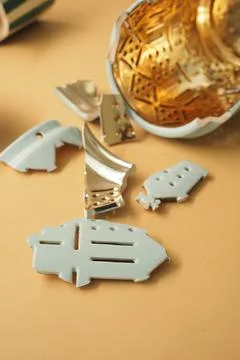 Broken pieces of a ceramic object on a plain surface in a workshop setting Stock Photos