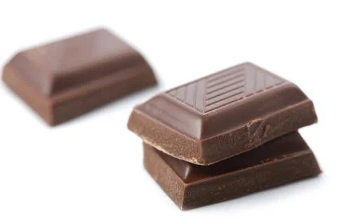 Broken pieces of chocolate isolated Stock Photos