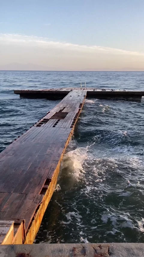 Broken Pier in a Windy Day with Waves in Slow-motion (Vertical) Stock Footage 306555566