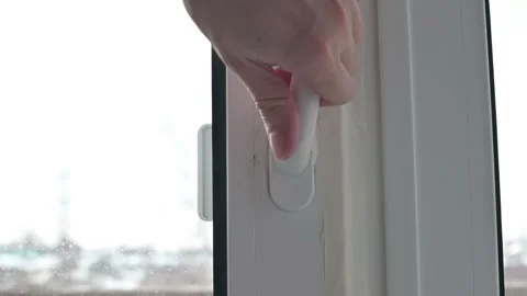 Broken plastic window handle rotates 360 degrees. person uses their hands to Stock Footage 337111497