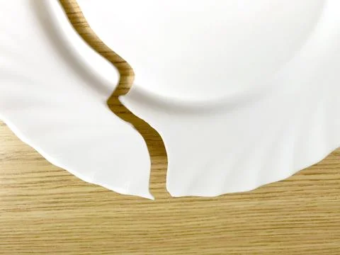 Broken plate on the table, on the floor. Stock Photos