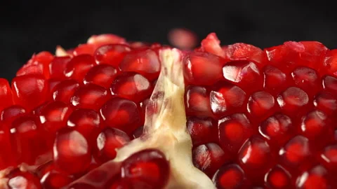 Broken pomegranate fruit close up on black background Stock Footage 141285529