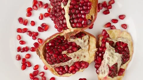 Broken pomegranate on a plate. Video stock 240276833