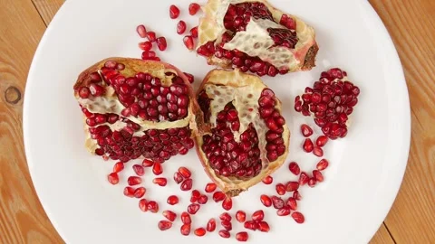 Broken pomegranate on a plate. Stock Footage 243341782
