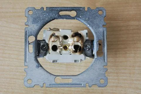 Broken power overload switch electric outlet. Electric short circuit causing  Stock Photos