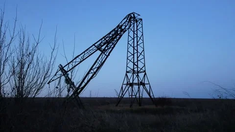 A broken power pole in the middle of the field. Russia attacks Ukraine's energy Stock-Footage 224664922
