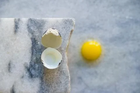 Broken quail egg with shell on white background Stock Photos