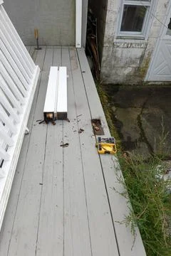 Broken rail posts on a wooden deck that is being repaired Stock Photos
