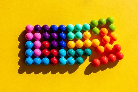 Broken rectangle made of multicolored bright plastic parts with shadow on yel Stock Photos