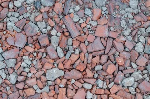 Broken red brick and grey stone pieces on ground Stock Photos