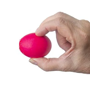 Broken red Easter egg in the hand of an elderly woman is isolated on a white  Stock Photos