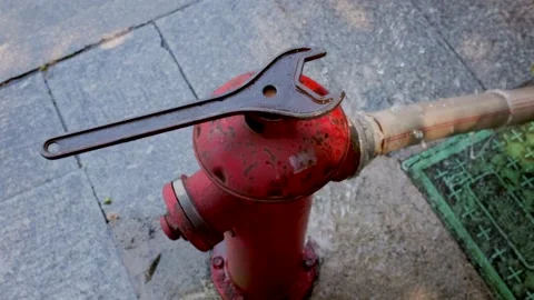 Broken red fire hydrant that is squirting water Stock Footage 162176852