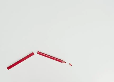 Broken red pencil on a white background Stock Photos