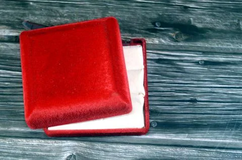A broken red velvet presentation box, typically used for storing, or presen.. Stock Photos