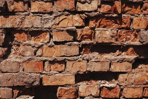 Broken Red Wall Background. Old brick wall texture. Stock Photos