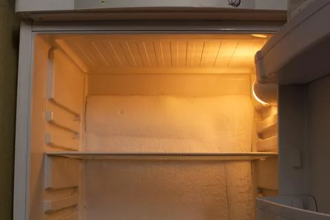 Broken refrigerator with snow inside need repairing. Icing on the back wall Stock Photos