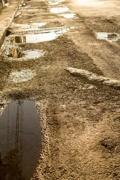 Broken road surface with water. Stock Photos
